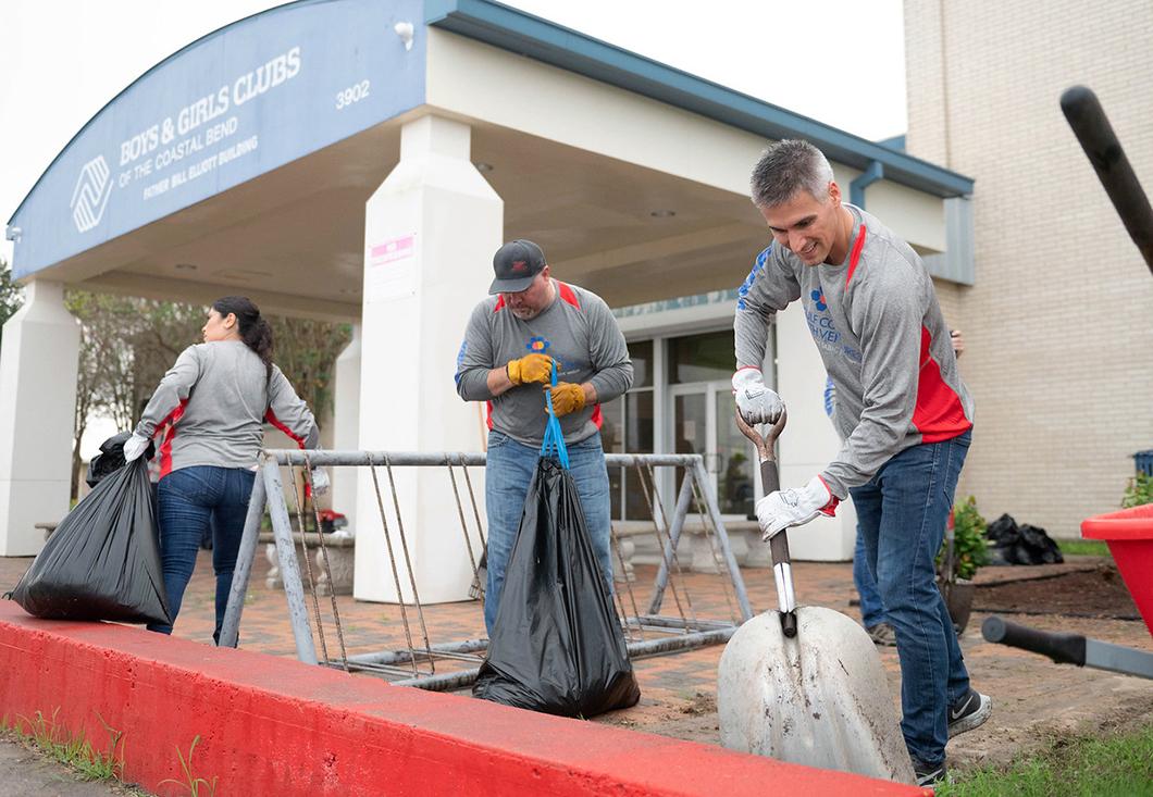 Volunteers work on landscaping outside the Boys & Girls Clubs of the Coastal Bend facility.