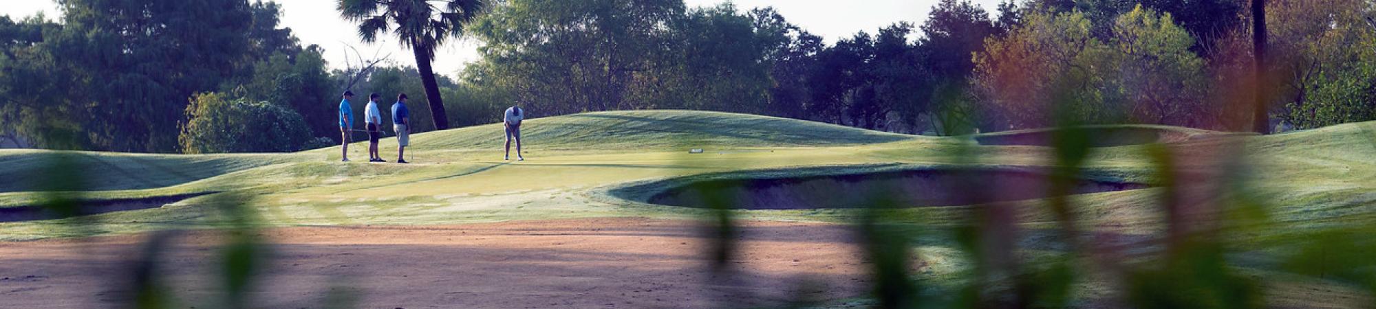 Golfers on a hill.
